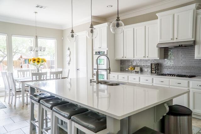 White toned kitchen with tall countertops and good lighting